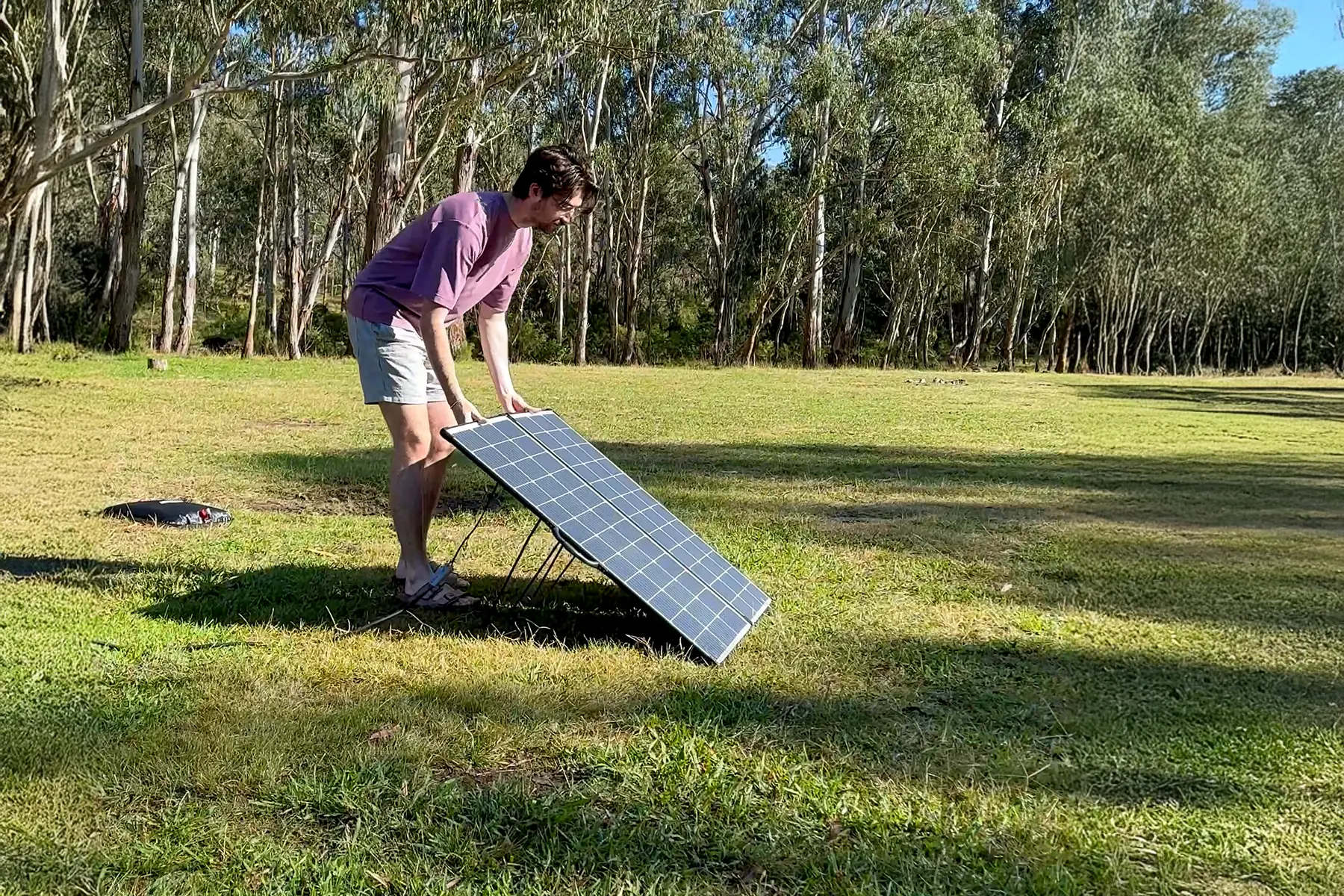 Person moving solarcase out of the shade